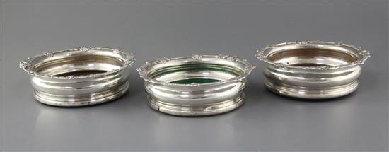 A pair of George III Irish silver mounted wine coasters and one other similar coaster, 17.3cm.